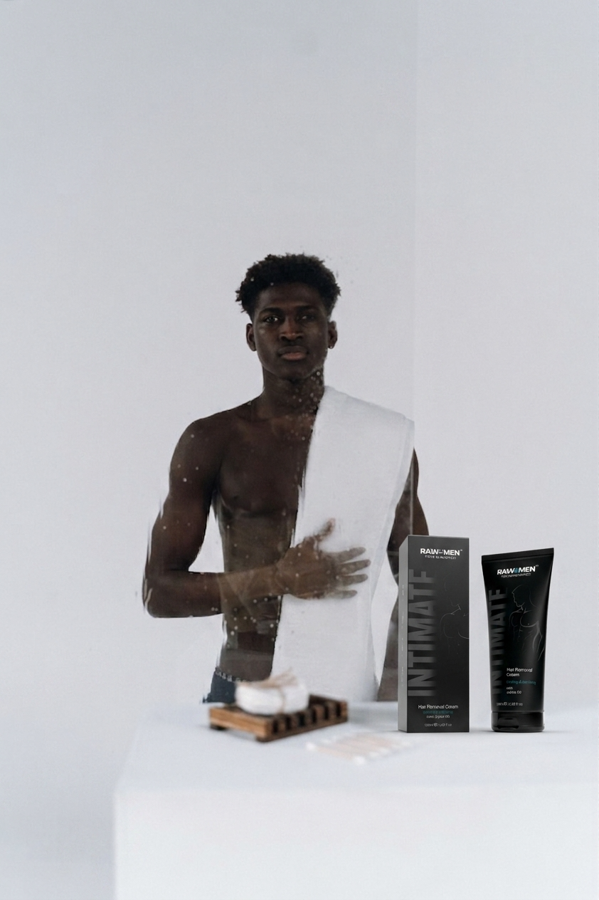 Man toweling off next to the RAW4MEN Intimate hair removal cream box and tube